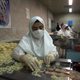A veiled worker sorts condoms for packaging at the Takestan, Iran condom factory, Sept. 23 1999.